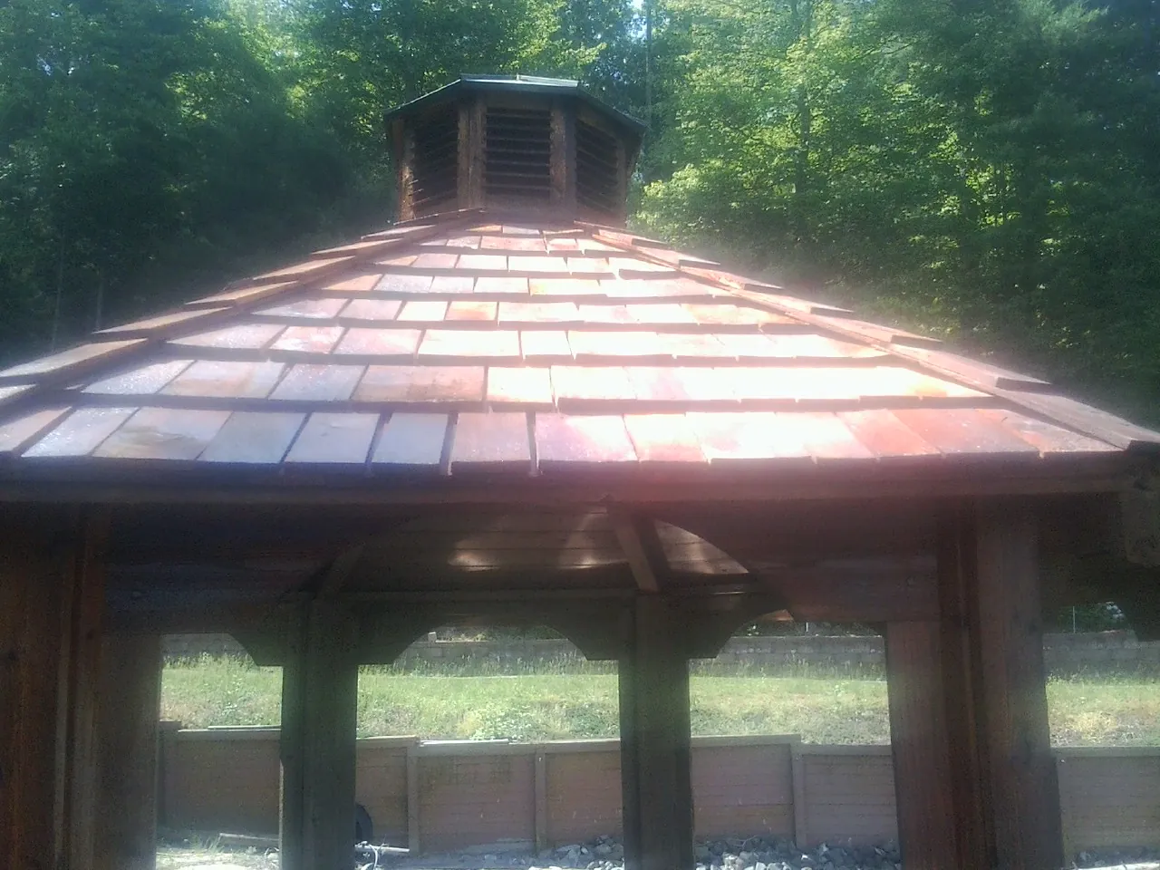 New cedar shake roof and cupola on a lakeside gazebo in Leigh