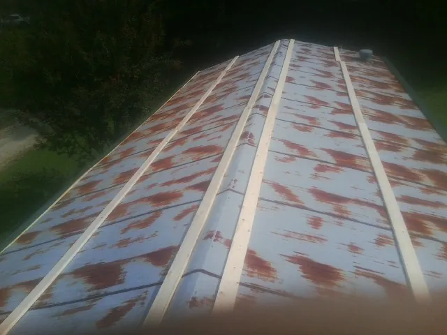 Rusted metal roof panels with new wood purlins before replacement — Storm Damage Roof Repair in Leigh by Roofing Brothers
