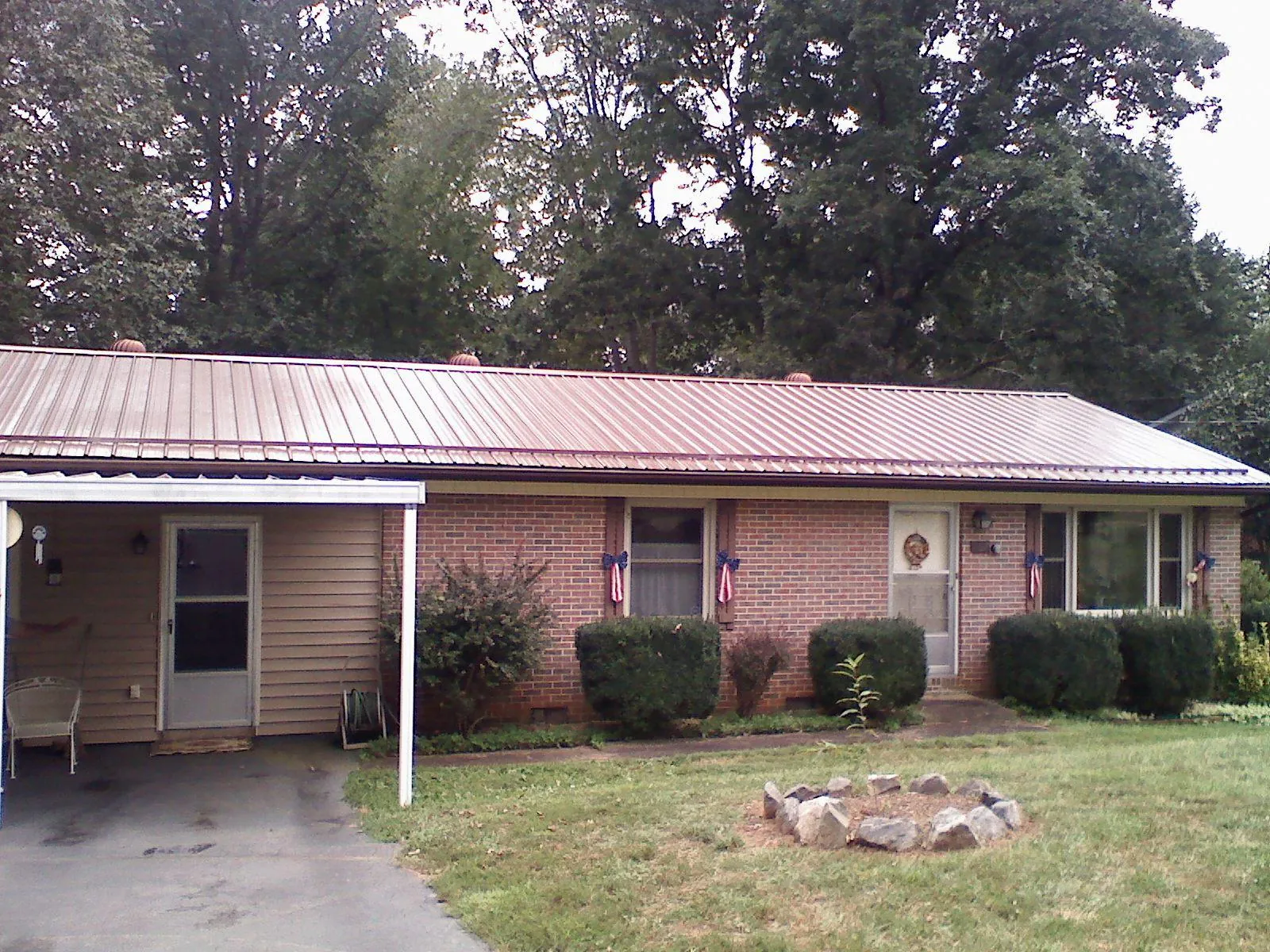 Bronze metal roof and carport on a brick ranch home — Roof Repair work by our crew in Leigh